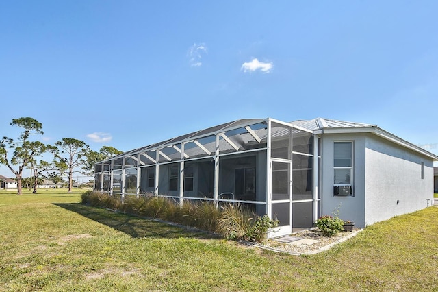 back of property featuring a yard and glass enclosure