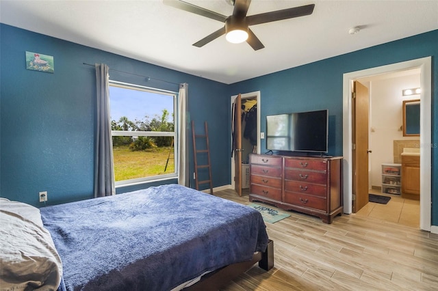 bedroom featuring ensuite bath, ceiling fan, and light hardwood / wood-style flooring