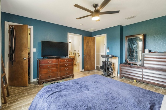 bedroom featuring ensuite bath, ceiling fan, and light wood-type flooring