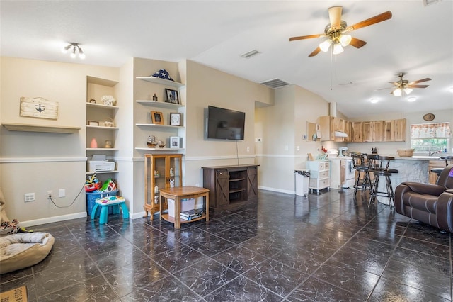 tiled living room featuring ceiling fan and built in shelves