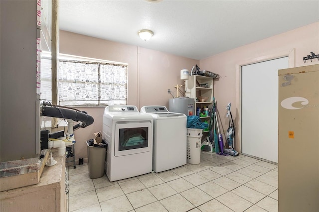 laundry area with water heater, light tile flooring, and separate washer and dryer