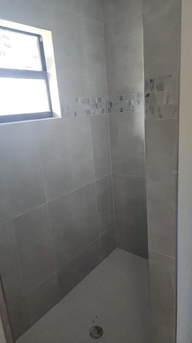 bathroom with a tile shower