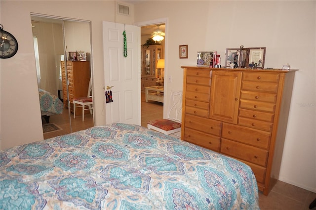 tiled bedroom with a closet