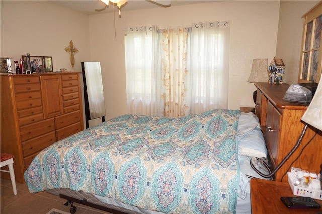 bedroom with tile floors and ceiling fan