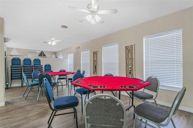 dining area with ceiling fan and wood-type flooring