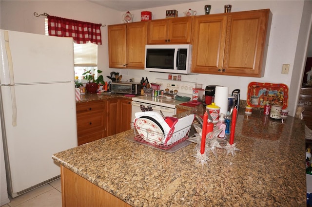 kitchen with white appliances, light tile flooring, and light stone countertops