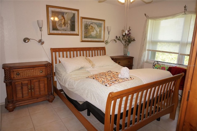 tiled bedroom featuring ceiling fan