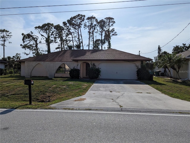 view of front of house with a front yard and a garage