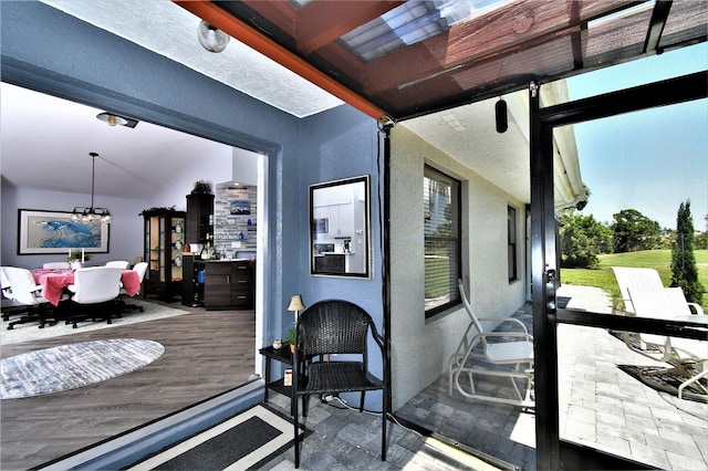 sunroom / solarium with a notable chandelier