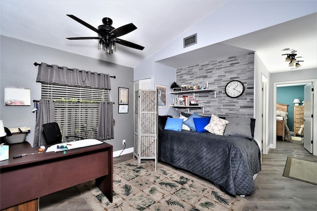 bedroom with lofted ceiling, ceiling fan, and hardwood / wood-style flooring