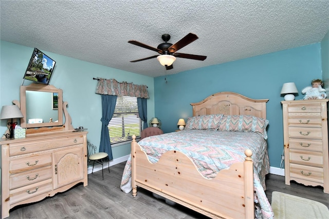 bedroom featuring hardwood / wood-style floors, ceiling fan, and a textured ceiling