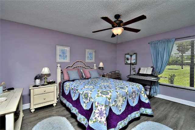 bedroom with dark hardwood / wood-style floors, a textured ceiling, and ceiling fan