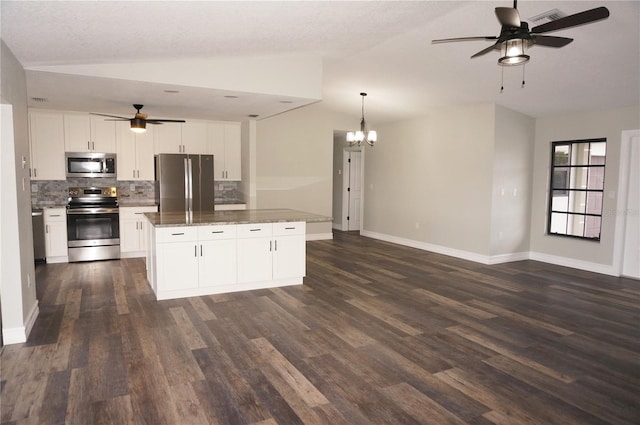 kitchen featuring white cabinetry, dark hardwood / wood-style floors, ceiling fan with notable chandelier, and stainless steel appliances