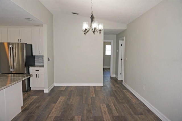 kitchen featuring decorative light fixtures, a notable chandelier, white cabinetry, and dark hardwood / wood-style flooring