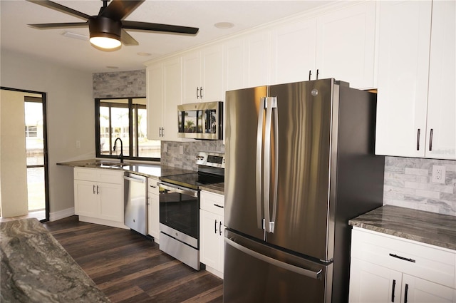 kitchen featuring backsplash, stainless steel appliances, ceiling fan, and white cabinetry