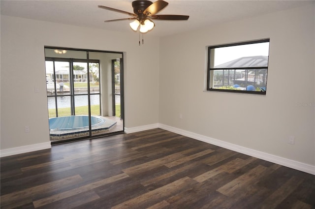 unfurnished room featuring ceiling fan and dark hardwood / wood-style flooring