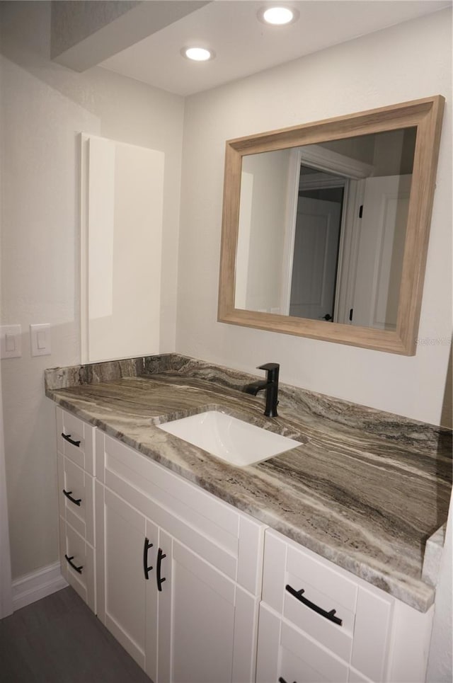 bathroom featuring wood-type flooring and vanity