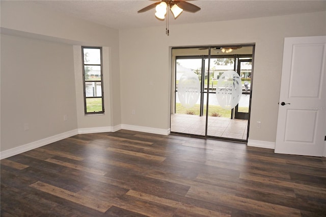 unfurnished room featuring ceiling fan and dark hardwood / wood-style flooring