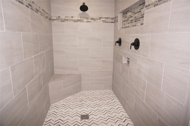 bathroom with a tile shower