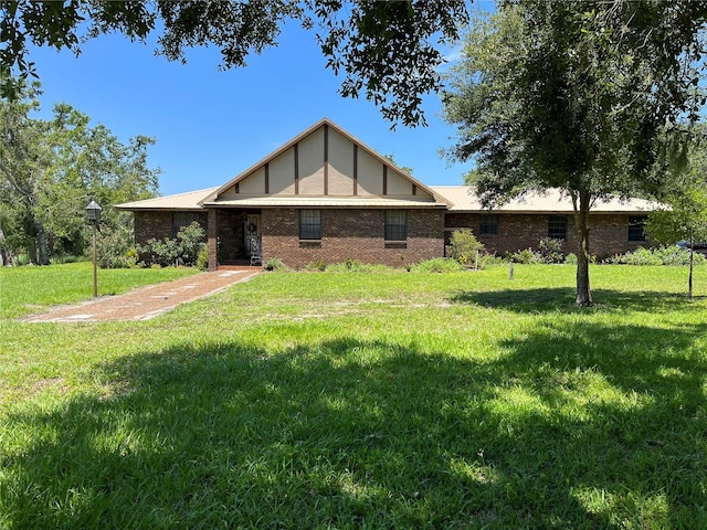 tudor-style house featuring a front lawn