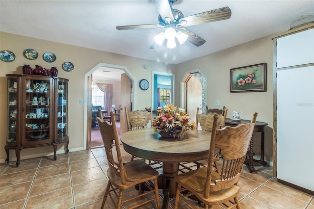 dining room featuring light tile floors and ceiling fan