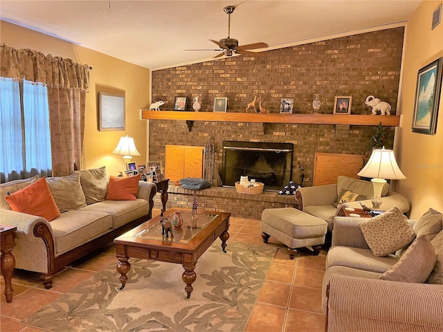 living room featuring brick wall, a brick fireplace, ceiling fan, tile floors, and vaulted ceiling