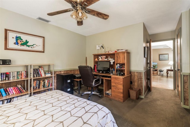 bedroom featuring dark tile floors and ceiling fan