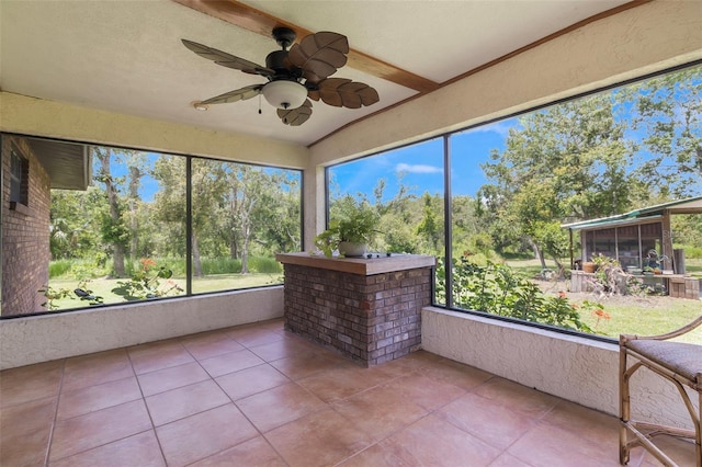 unfurnished sunroom with plenty of natural light, ceiling fan, and lofted ceiling