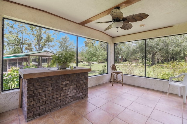 unfurnished sunroom with ceiling fan and a wealth of natural light