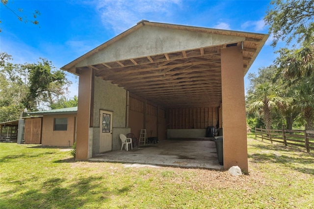 exterior space featuring a lawn and a carport