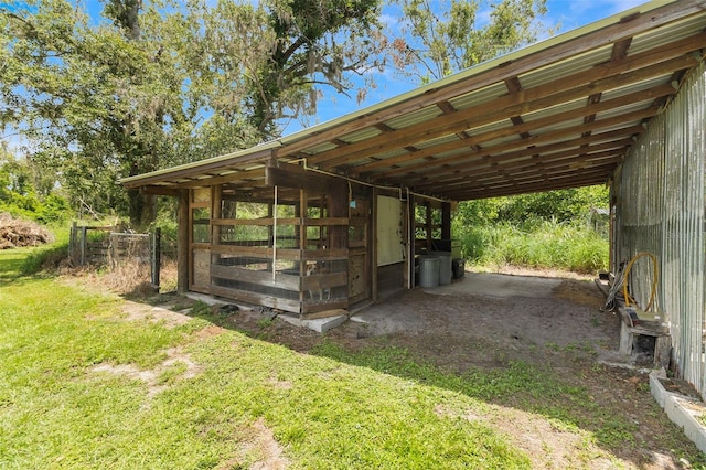 view of stable with a lawn and an outdoor structure