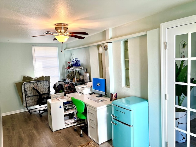 office area with a textured ceiling, dark hardwood / wood-style floors, and ceiling fan