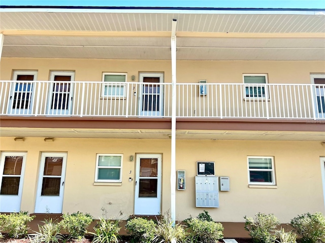 back of property featuring a balcony