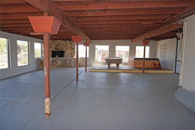 view of terrace with a covered hot tub and a stone fireplace