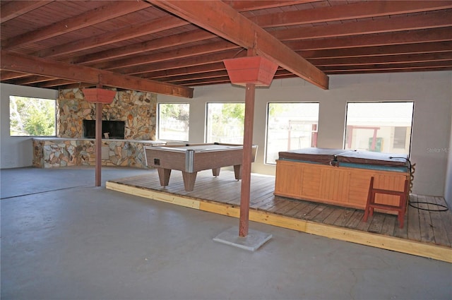 interior space featuring wood ceiling, billiards, and a stone fireplace