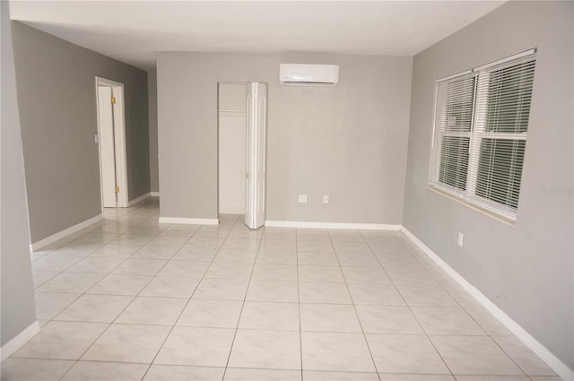 tiled spare room with a wall unit AC