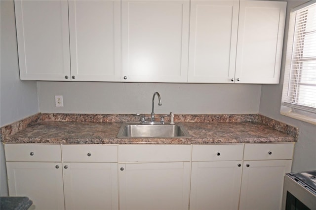 kitchen with white cabinetry and sink