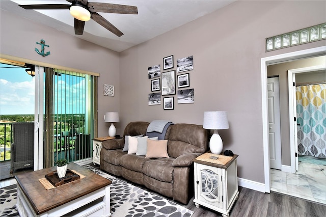 living room with dark wood-type flooring and ceiling fan