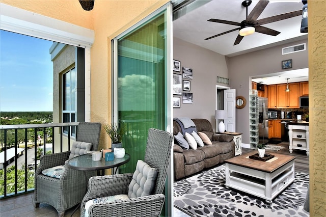 balcony featuring an outdoor living space and ceiling fan