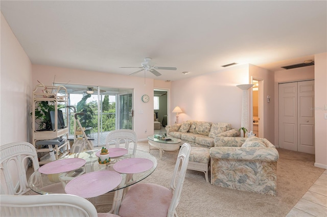 tiled living room with ceiling fan