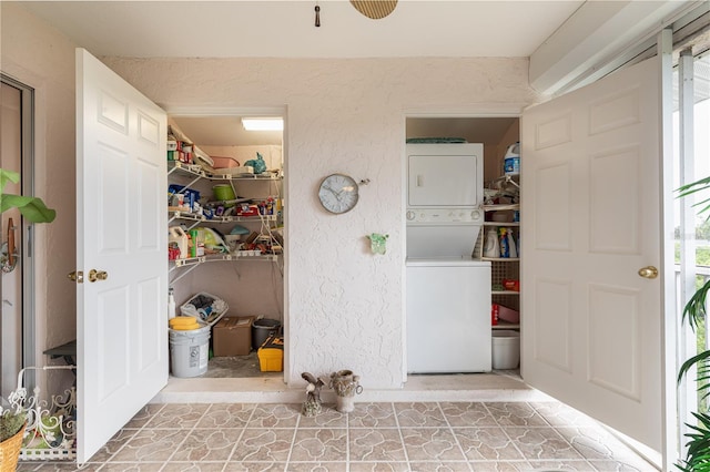 laundry room with stacked washing maching and dryer