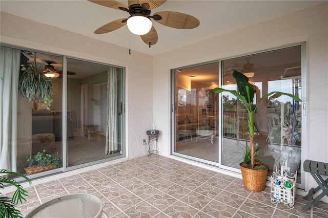 unfurnished sunroom with ceiling fan