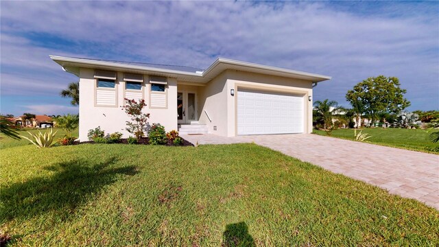 view of front facade with a front yard and a garage