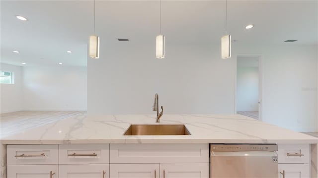 kitchen with dishwasher, white cabinets, sink, light stone countertops, and decorative light fixtures