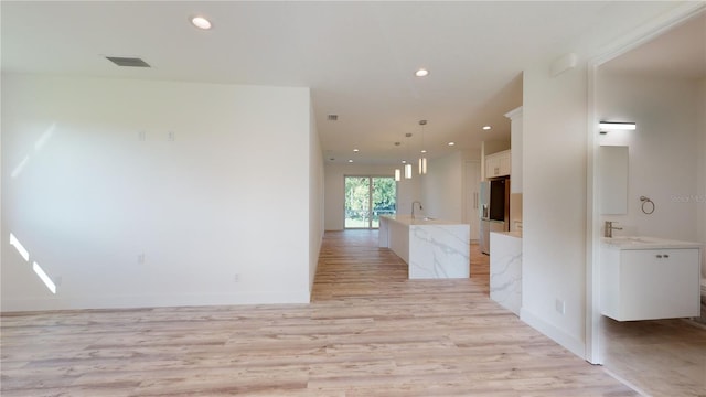 interior space featuring light hardwood / wood-style flooring and sink