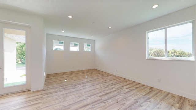 spare room with light hardwood / wood-style flooring