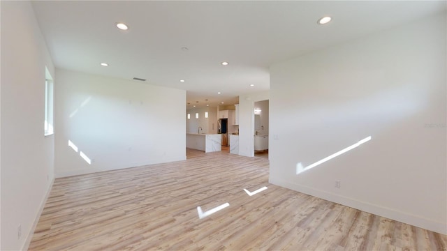 spare room featuring light wood-type flooring