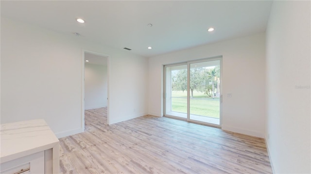 unfurnished room featuring light hardwood / wood-style floors