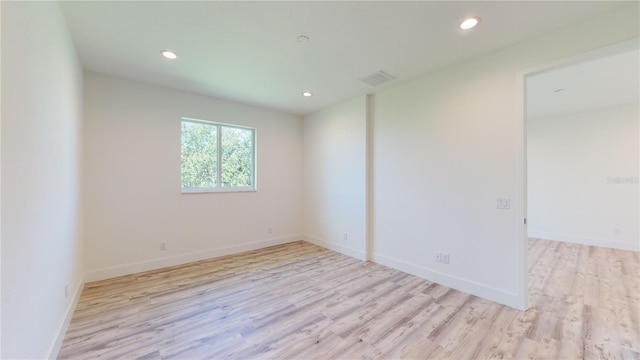 unfurnished room with light hardwood / wood-style flooring