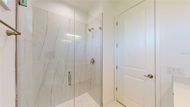 bathroom featuring a shower with shower door